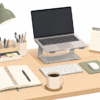 Flat vector illustration of a modern office desk featuring essential workspace accessories including a notebook, desk organizer, coffee mug, laptop stand, desk lamp, indoor plant, and office supplies on a clean white background.
