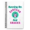 Running On Sarcasm And Snacks funny notebook featuring colorful cartoon artwork and playful pink and teal typography